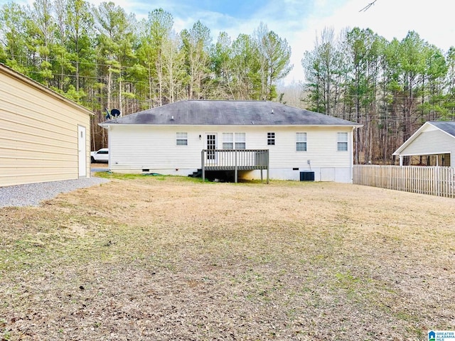 back of property featuring a wooden deck, a yard, and cooling unit