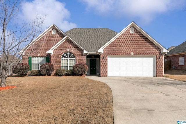 view of front of property featuring a garage and a front lawn