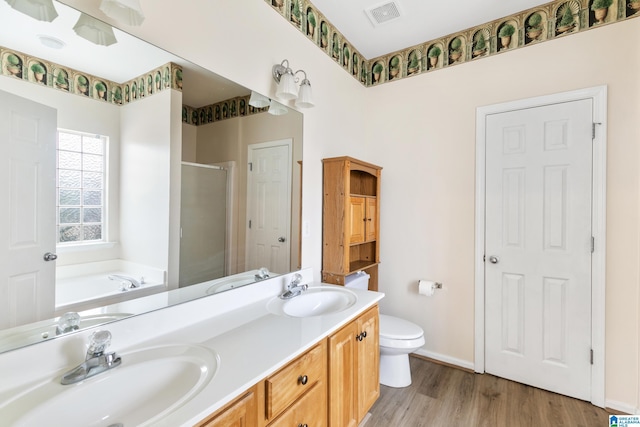 full bathroom featuring vanity, hardwood / wood-style floors, toilet, and separate shower and tub