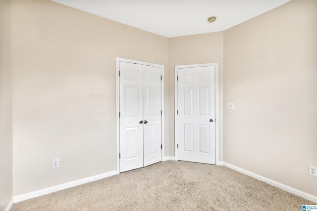 unfurnished bedroom featuring carpet flooring and a closet