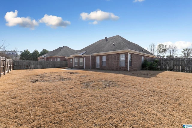 back of house featuring a yard