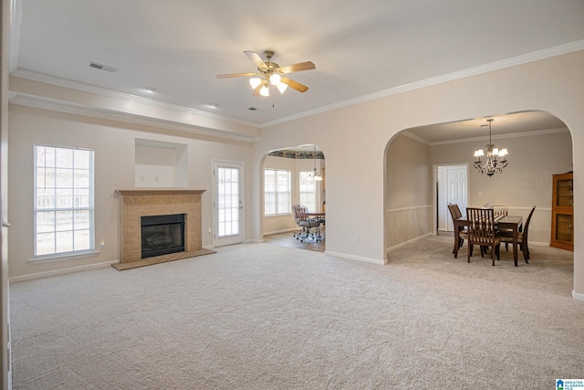 carpeted living room with ornamental molding and ceiling fan with notable chandelier