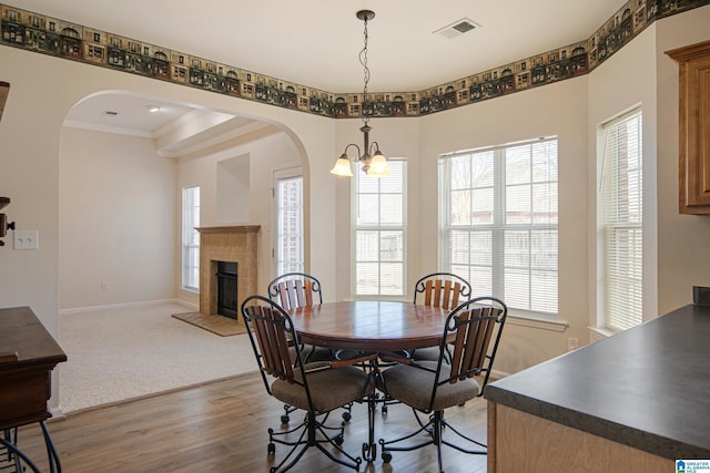 dining room featuring hardwood / wood-style floors, a notable chandelier, and ornamental molding