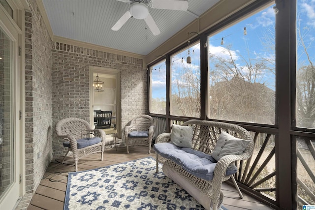 sunroom / solarium featuring ceiling fan