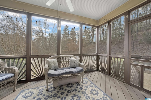 sunroom / solarium with a healthy amount of sunlight and ceiling fan