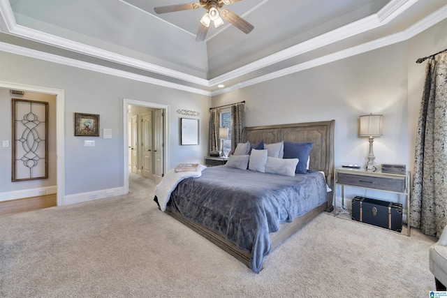 bedroom featuring crown molding, ceiling fan, a raised ceiling, and light carpet