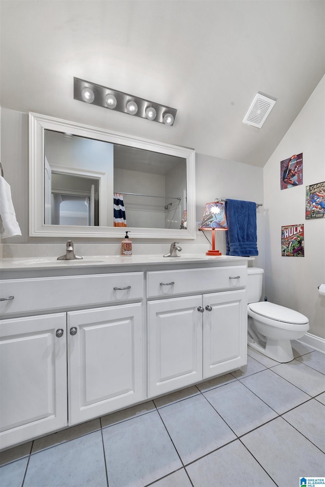 bathroom with vanity, lofted ceiling, tile patterned floors, and toilet