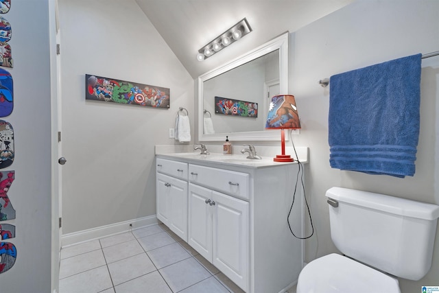 bathroom featuring lofted ceiling, vanity, tile patterned flooring, and toilet