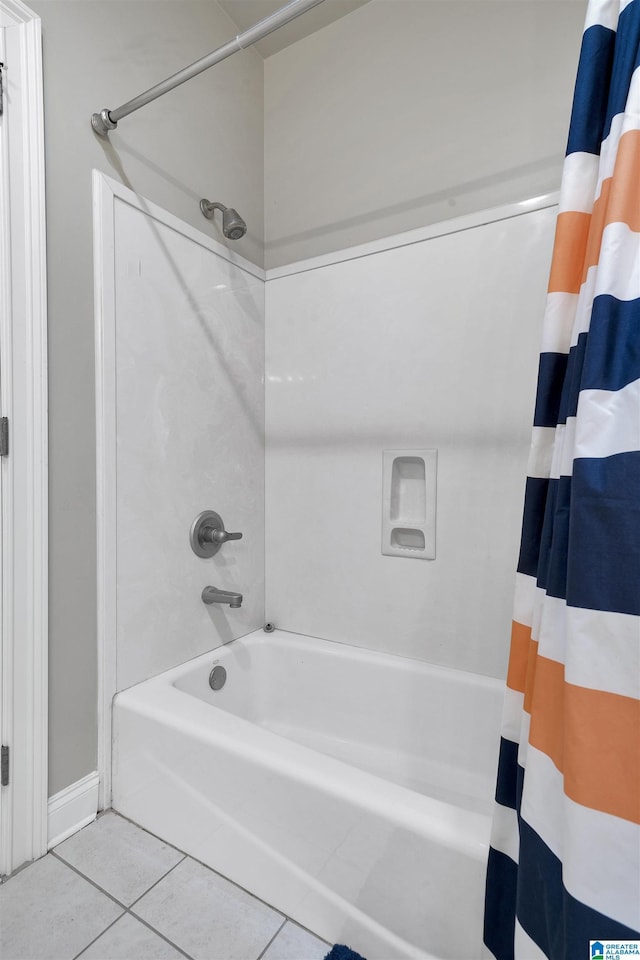 bathroom featuring shower / bath combination with curtain and tile patterned flooring