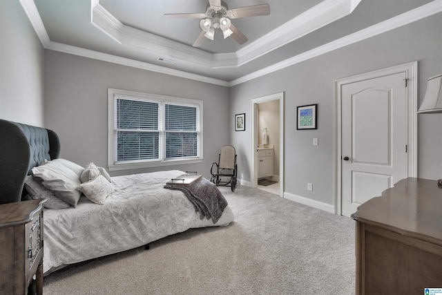 bedroom featuring ensuite bath, ceiling fan, carpet floors, ornamental molding, and a raised ceiling