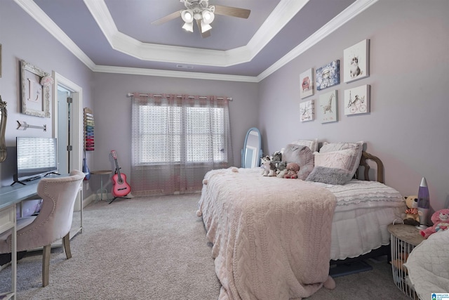 bedroom featuring ceiling fan, ornamental molding, a tray ceiling, and light carpet