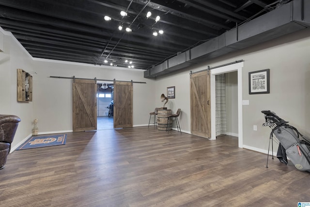 basement featuring hardwood / wood-style flooring and a barn door