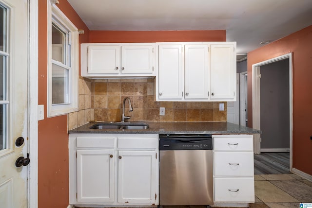 kitchen with white cabinetry, dishwasher, sink, and decorative backsplash