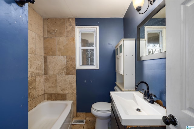 bathroom with sink, a wealth of natural light, toilet, and a tub to relax in