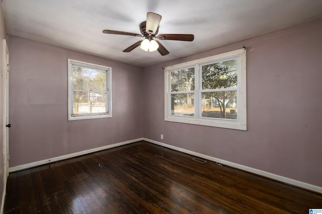 spare room with ceiling fan and dark hardwood / wood-style floors