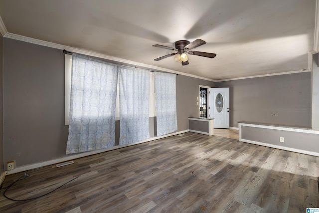 spare room with hardwood / wood-style floors, crown molding, and ceiling fan