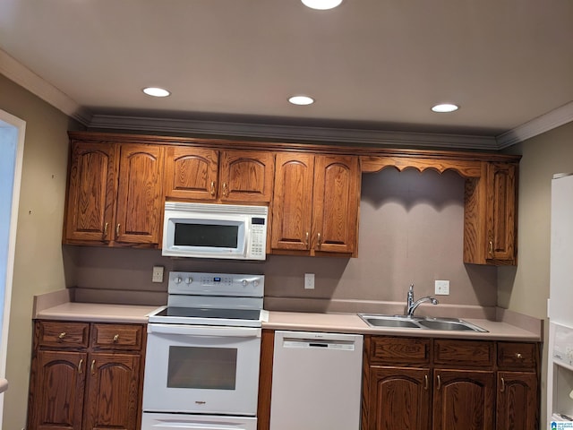 kitchen featuring crown molding, sink, and white appliances