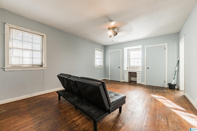 sitting room featuring dark hardwood / wood-style floors and ceiling fan