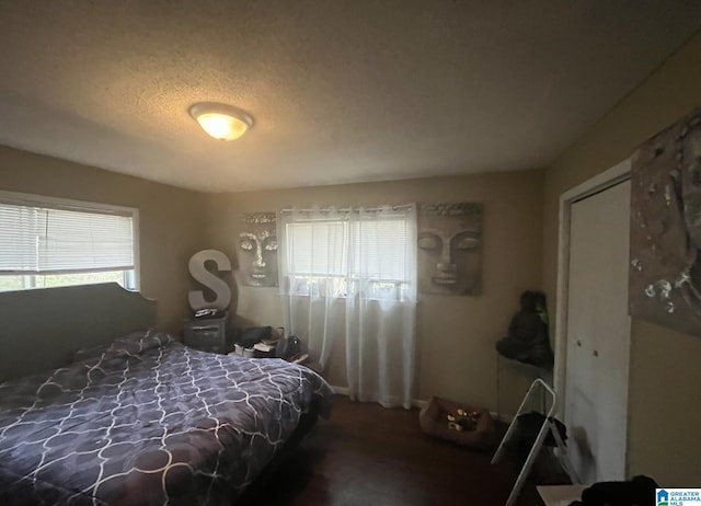 bedroom with multiple windows and a textured ceiling