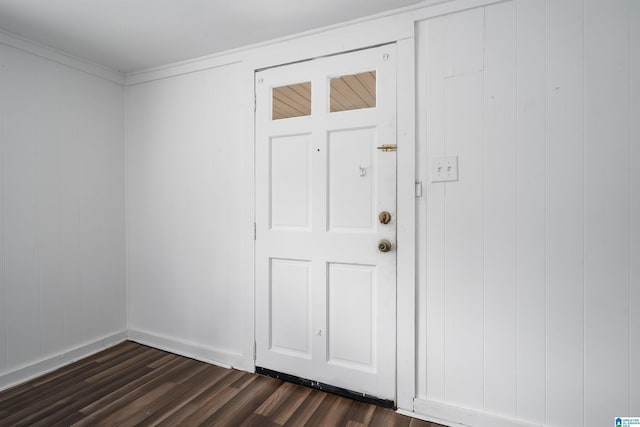 entryway featuring dark wood-type flooring and ornamental molding