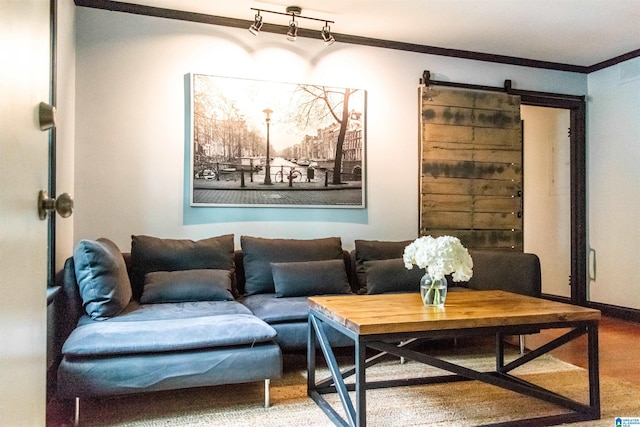 living room with crown molding, a barn door, and rail lighting