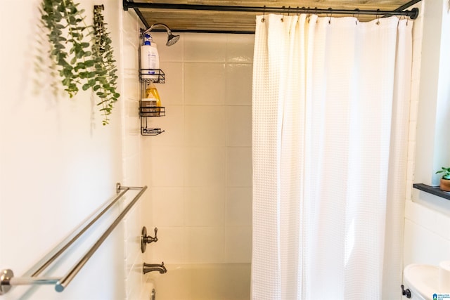 bathroom with shower / tub combo with curtain and toilet