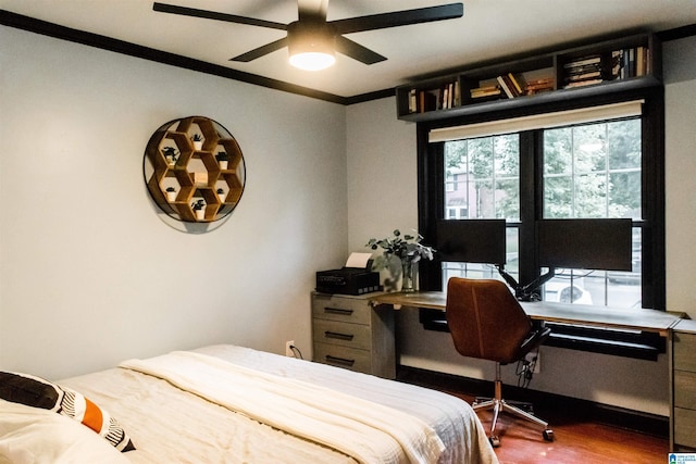 bedroom featuring wood-type flooring, ornamental molding, and ceiling fan