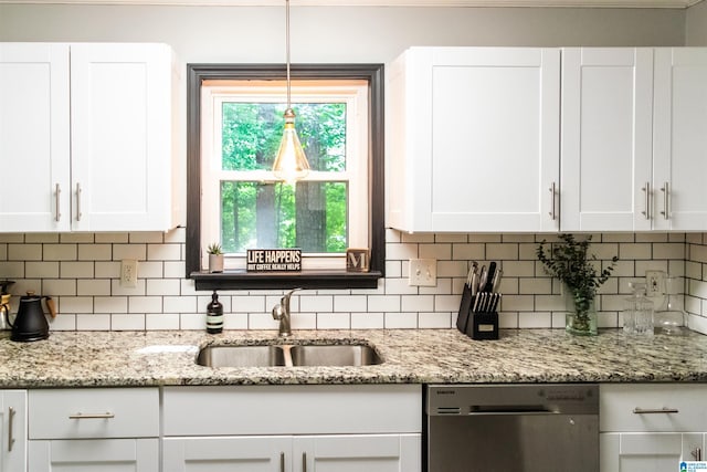 kitchen with pendant lighting, sink, white cabinetry, light stone counters, and stainless steel dishwasher