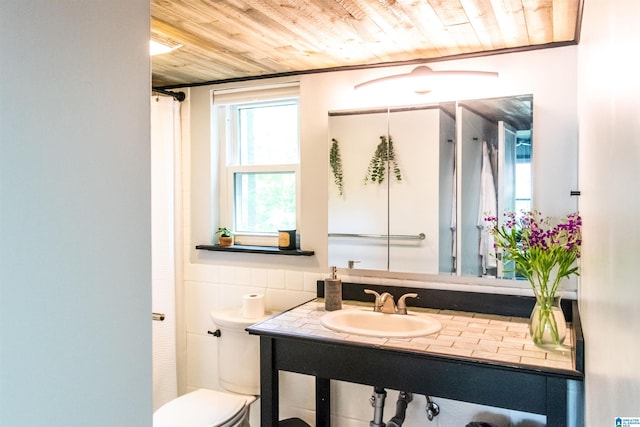 bathroom featuring sink, wood ceiling, and toilet