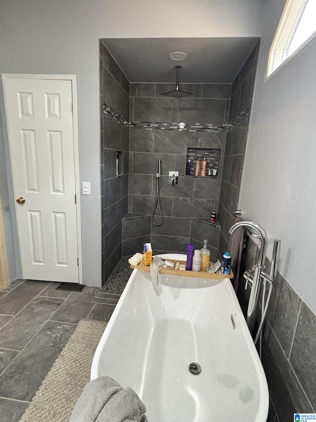 bathroom with tile walls and a tile shower