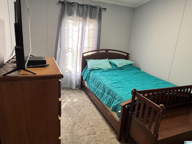 bedroom with crown molding and carpet