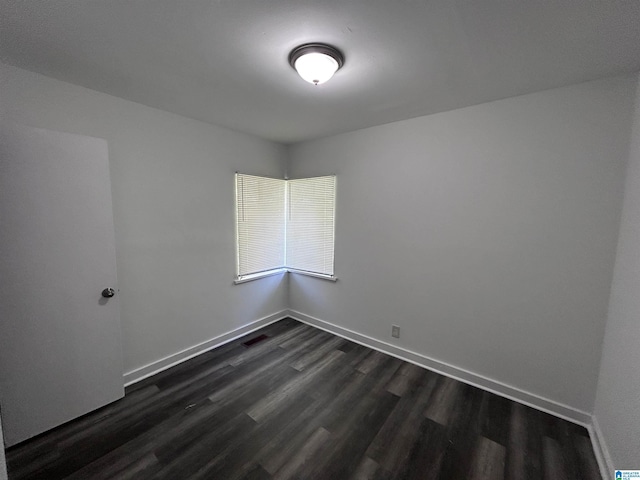 unfurnished room featuring dark wood-type flooring