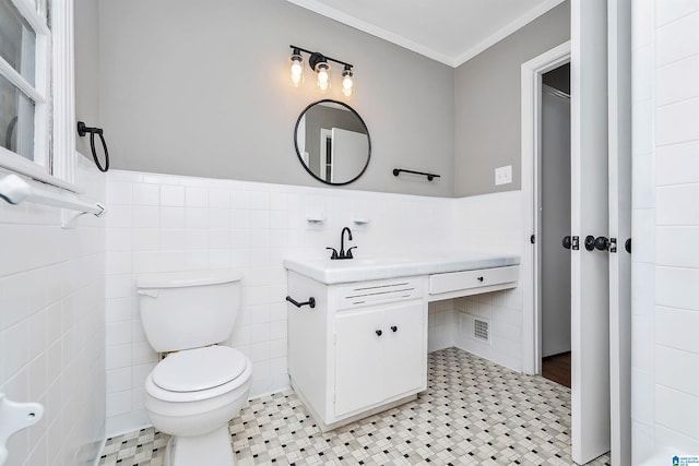 bathroom with vanity, tile walls, and toilet