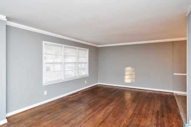 spare room featuring crown molding and dark hardwood / wood-style floors