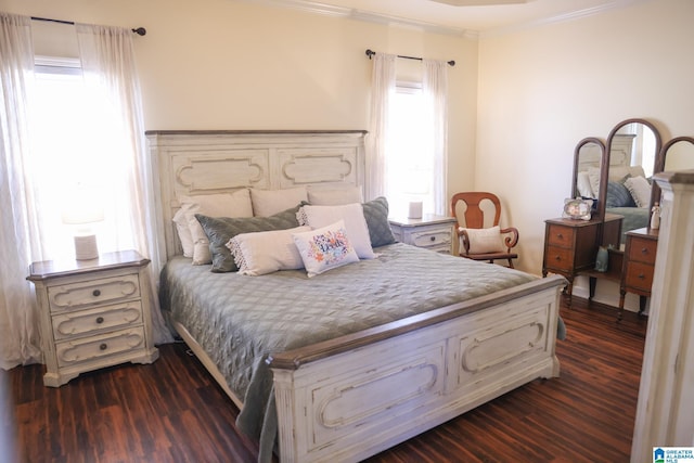 bedroom featuring ornamental molding and dark hardwood / wood-style flooring