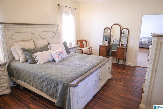 bedroom with crown molding and dark hardwood / wood-style floors