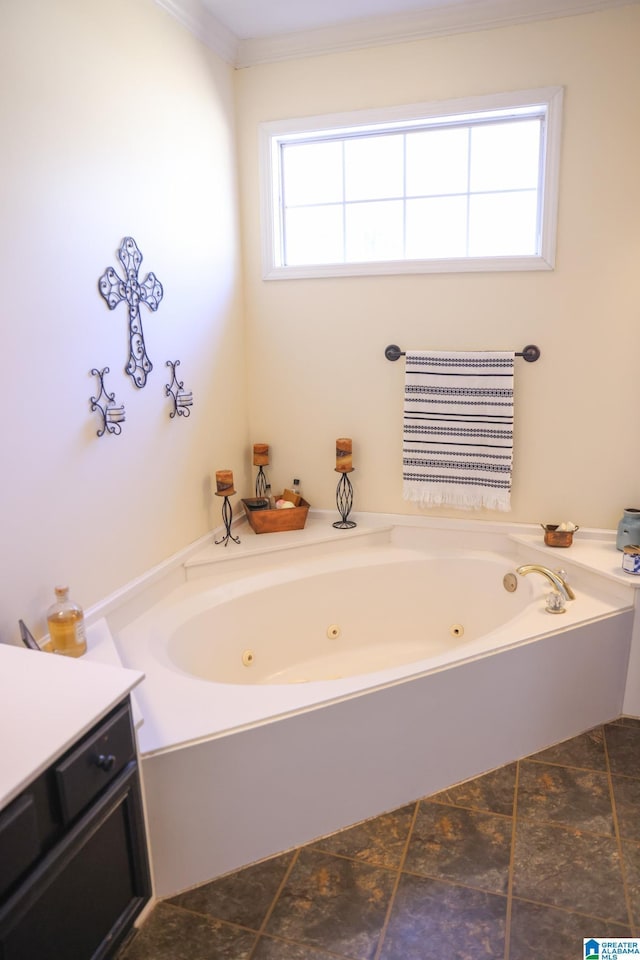 bathroom featuring crown molding, vanity, and a tub