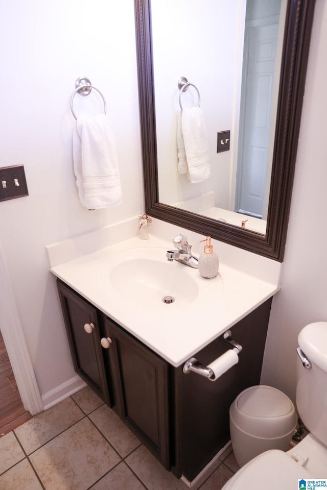 bathroom featuring vanity, tile patterned floors, and toilet