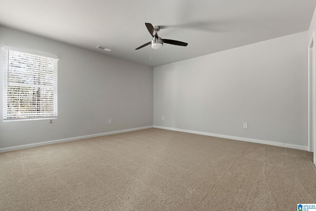 spare room with ceiling fan and carpet floors