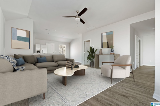 living room featuring ceiling fan, lofted ceiling, and hardwood / wood-style floors