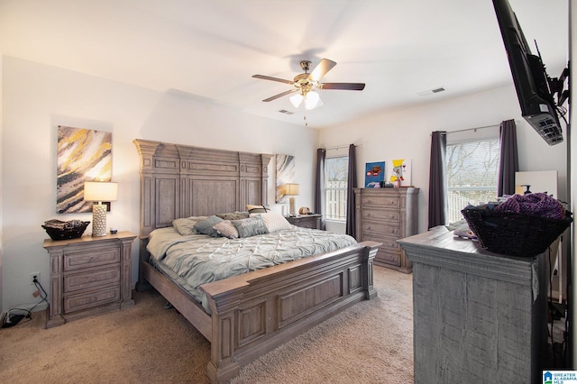 bedroom featuring light carpet and ceiling fan