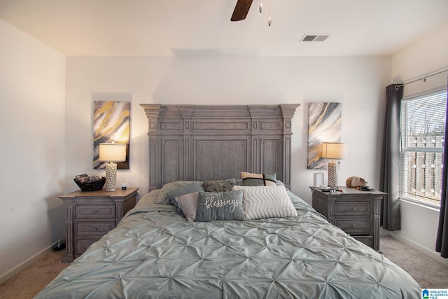 bedroom featuring ceiling fan and light carpet