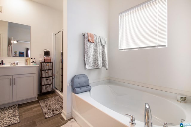 bathroom with vanity and independent shower and bath