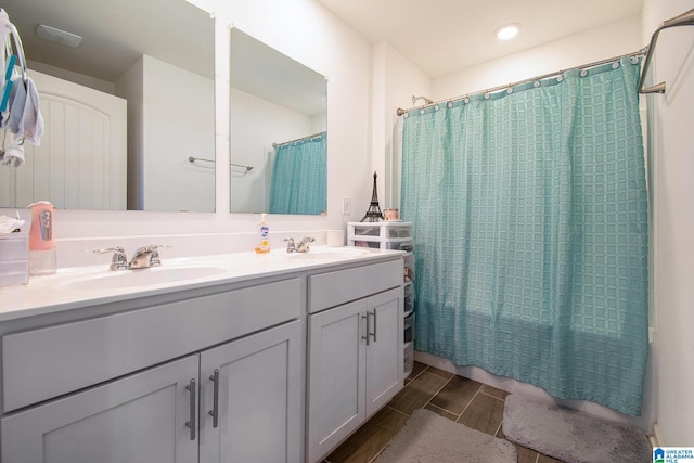 bathroom featuring shower / tub combo and vanity