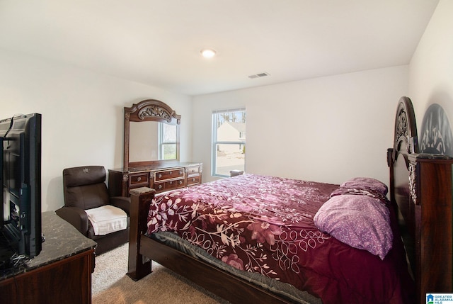 bedroom featuring light carpet