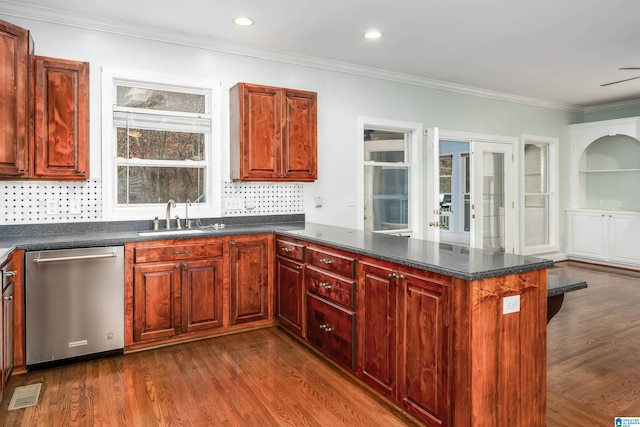 kitchen featuring sink, crown molding, dark hardwood / wood-style floors, dishwasher, and kitchen peninsula