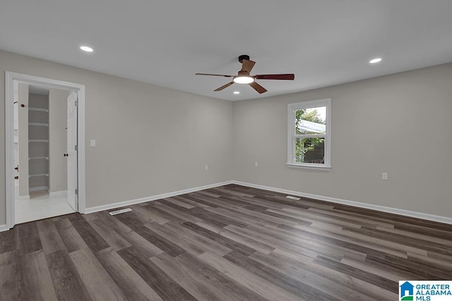 unfurnished room featuring dark hardwood / wood-style floors and ceiling fan