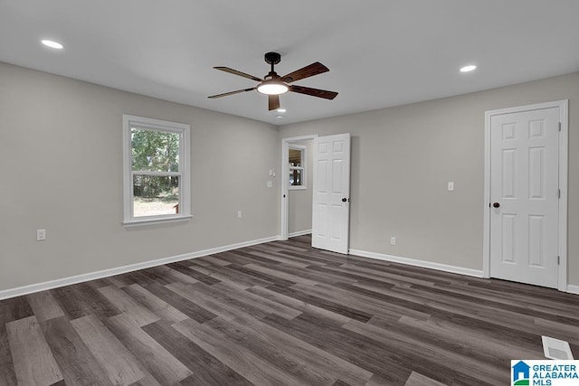 spare room with ceiling fan and dark hardwood / wood-style floors