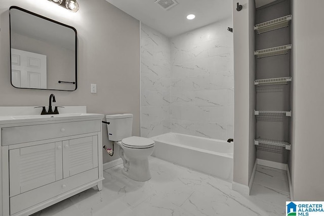 full bathroom featuring vanity, tiled shower / bath combo, and toilet