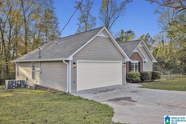 view of home's exterior with central AC, a garage, and a yard